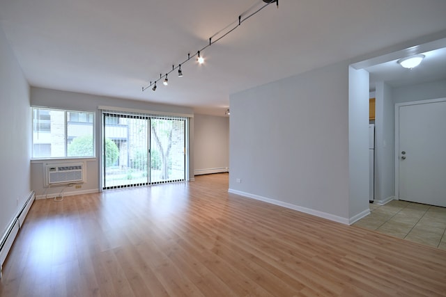 1806 Hemlock Pl Unit 105, Schaumburg, IL 60173 - spare room featuring a baseboard heating unit, an AC wall unit, rail lighting, and light wood-style floors