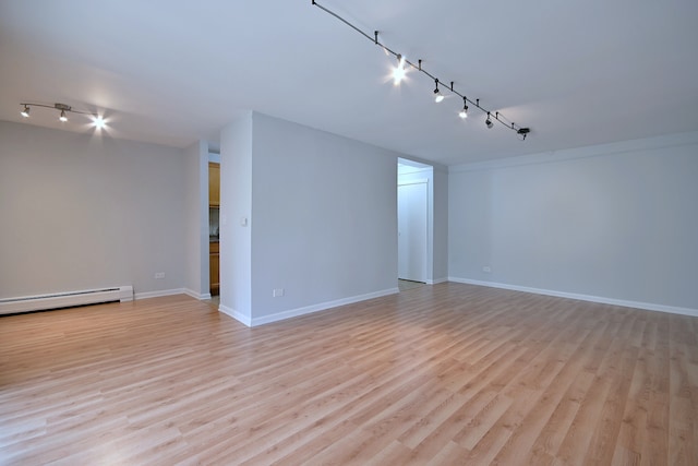 1806 Hemlock Pl Unit 105, Schaumburg, IL 60173 - empty room featuring track lighting, a baseboard radiator, light wood-style flooring, and baseboards