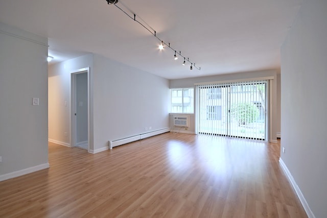 1806 Hemlock Pl Unit 105, Schaumburg, IL 60173 - empty room with baseboard heating, light wood-type flooring, track lighting, and baseboards