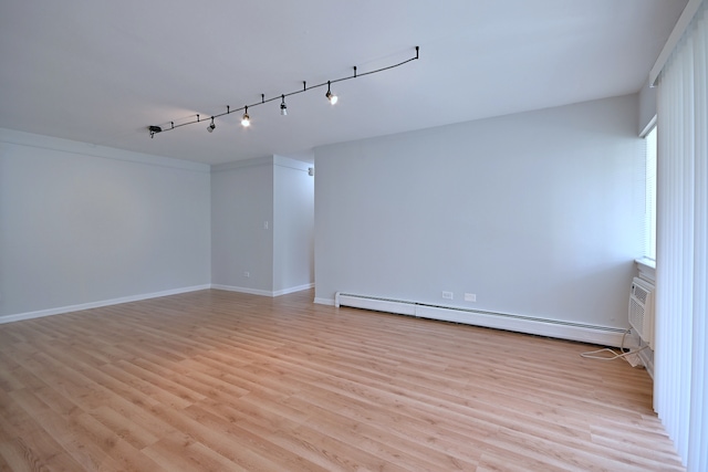 1806 Hemlock Pl Unit 105, Schaumburg, IL 60173 - empty room with light wood-type flooring, a baseboard radiator, baseboards, and rail lighting