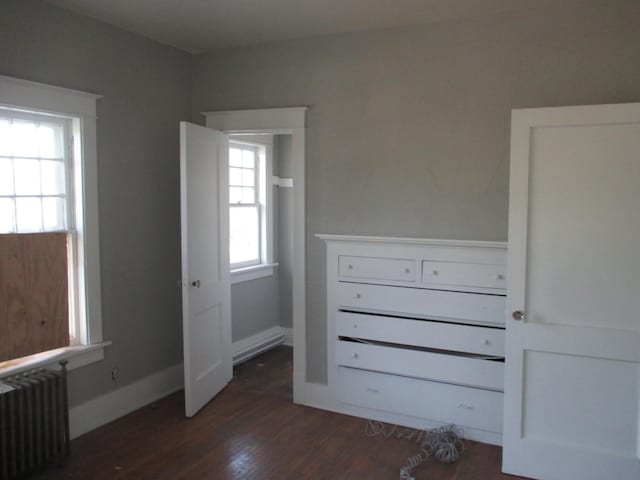 312 Union St, Joliet, IL 60433 - unfurnished bedroom featuring radiator heating unit, dark wood-type flooring, and baseboards