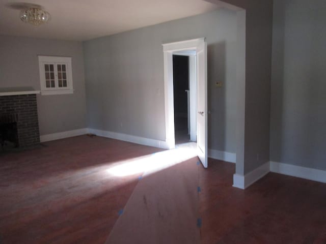 312 Union St, Joliet, IL 60433 - unfurnished living room featuring wood finished floors, baseboards, and a brick fireplace