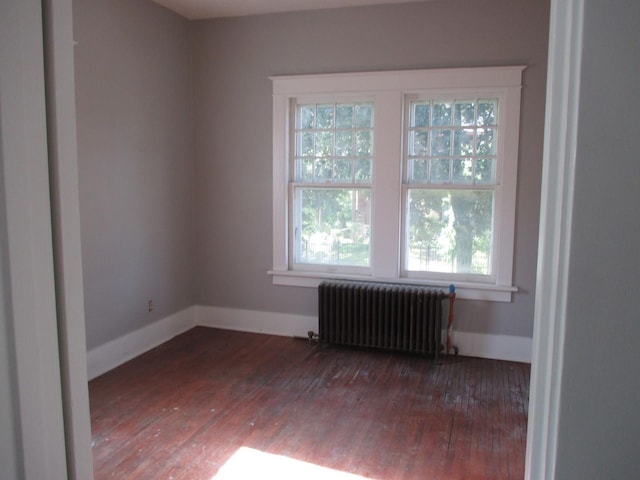 312 Union St, Joliet, IL 60433 - unfurnished room with radiator heating unit, wood-type flooring, and baseboards