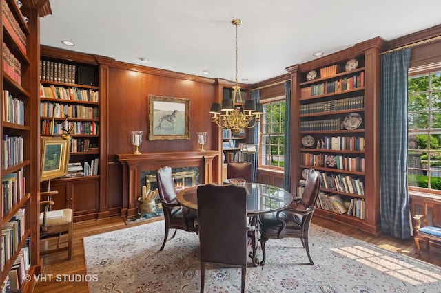 539 N E Ave, Oak Park, IL 60302 - dining space with a chandelier, wood finished floors, crown molding, wooden walls, and recessed lighting