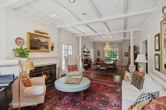 539 N E Ave, Oak Park, IL 60302 - living room featuring healthy amount of natural light, wood finished floors, decorative columns, beamed ceiling, and a chandelier