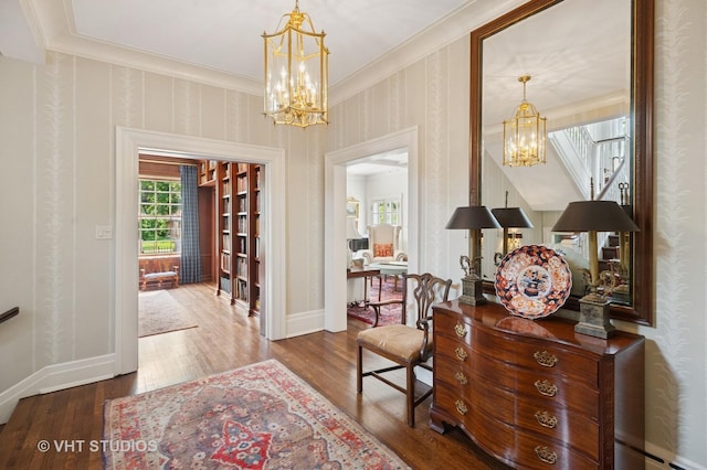 539 N E Ave, Oak Park, IL 60302 - foyer entrance with a chandelier, ornamental molding, wood finished floors, a baseboard radiator, and wallpapered walls