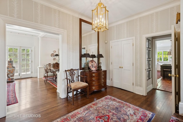 539 N E Ave, Oak Park, IL 60302 - living area featuring plenty of natural light, a chandelier, crown molding, hardwood / wood-style floors, and wallpapered walls