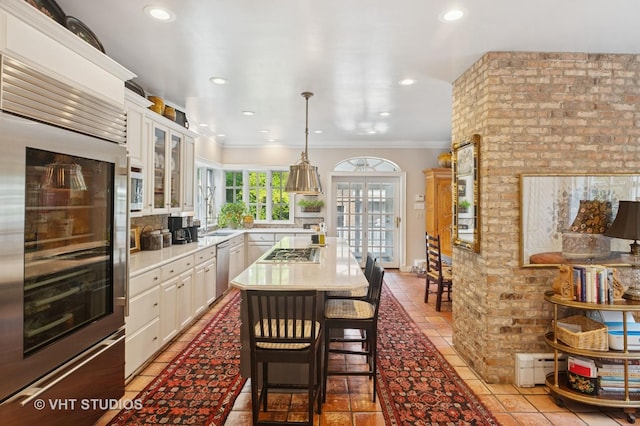 539 N E Ave, Oak Park, IL 60302 - kitchen featuring stainless steel appliances, light countertops, crown molding, white cabinets, and glass insert cabinets