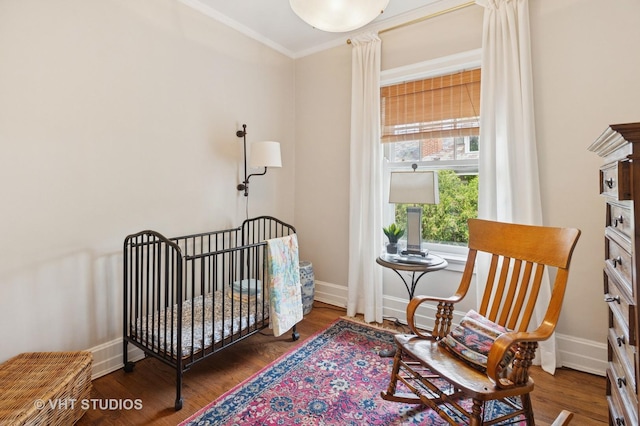 539 N E Ave, Oak Park, IL 60302 - bedroom featuring wood finished floors, crown molding, and a nursery area