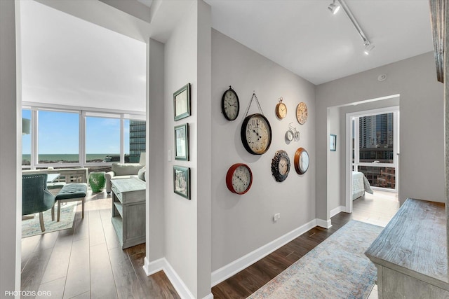 1201 S Prairie Ave Unit 1505, Chicago, IL 60605 - hallway featuring dark wood-type flooring, track lighting, baseboards, and a water view