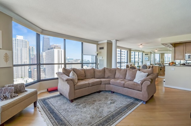 405 N Wabash Ave Unit 3403, Chicago, IL 60611 - living room with light wood-style floors, baseboards, ornamental molding, decorative columns, and a city view