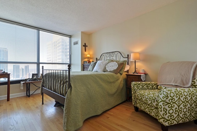 405 N Wabash Ave Unit 3403, Chicago, IL 60611 - bedroom with wood finished floors, baseboards, and a textured ceiling