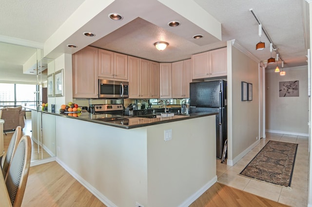 405 N Wabash Ave Unit 3403, Chicago, IL 60611 - kitchen featuring stainless steel appliances, dark countertops, ornamental molding, a peninsula, and baseboards