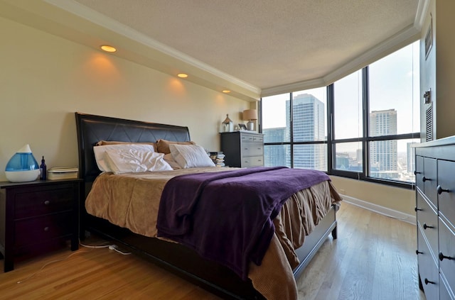 405 N Wabash Ave Unit 3403, Chicago, IL 60611 - bedroom featuring light wood-style floors, baseboards, recessed lighting, a textured ceiling, and ornamental molding