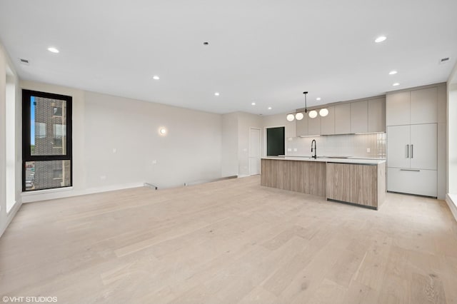 222 S Oakley Blvd Unit 3, Chicago, IL 60612 - kitchen featuring modern cabinets, light wood-style flooring, an island with sink, open floor plan, and recessed lighting
