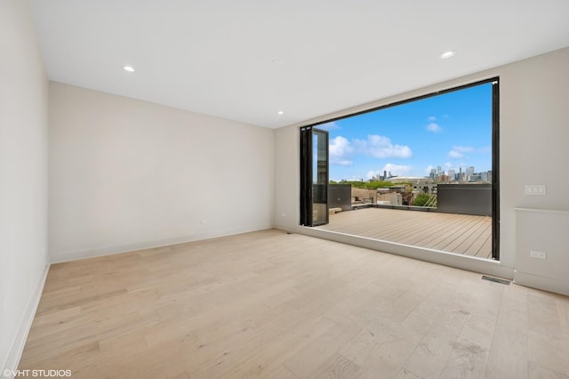 222 S Oakley Blvd Unit 3, Chicago, IL 60612 - unfurnished room with wood finished floors, baseboards, and recessed lighting