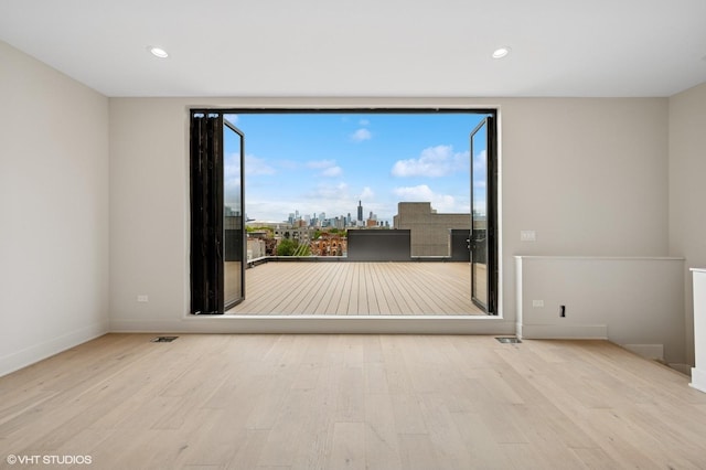 222 S Oakley Blvd Unit 3, Chicago, IL 60612 - unfurnished room with wood finished floors, baseboards, recessed lighting, and a view of city