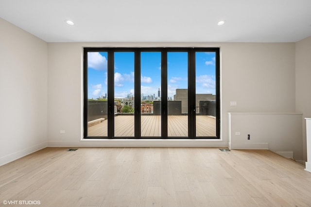 222 S Oakley Blvd Unit 3, Chicago, IL 60612 - empty room featuring light wood-style flooring, baseboards, and recessed lighting
