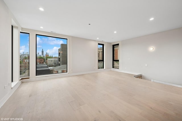 222 S Oakley Blvd Unit 3, Chicago, IL 60612 - empty room with light wood-type flooring, recessed lighting, baseboards, and a view of city