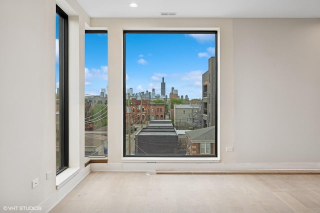 222 S Oakley Blvd Unit 3, Chicago, IL 60612 - empty room with a view of skyline, wood finished floors, and recessed lighting