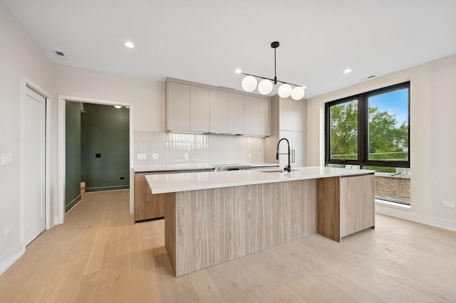 222 S Oakley Blvd Unit 3, Chicago, IL 60612 - kitchen featuring modern cabinets, a sink, light countertops, tasteful backsplash, and a large island