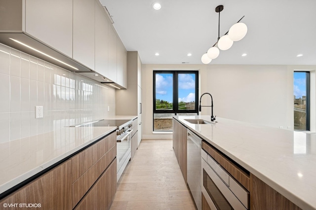 222 S Oakley Blvd Unit 3, Chicago, IL 60612 - kitchen with modern cabinets, stainless steel appliances, a sink, light stone counters, and recessed lighting