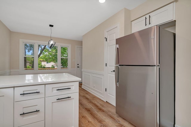 18024 Birch Ave, Country Club Hills, IL 60478 - kitchen with freestanding refrigerator, white cabinetry, light wood-type flooring, light stone countertops, and decorative light fixtures