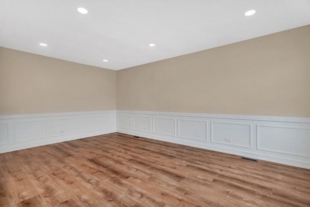 18024 Birch Ave, Country Club Hills, IL 60478 - spare room featuring light wood finished floors, wainscoting, a decorative wall, and recessed lighting