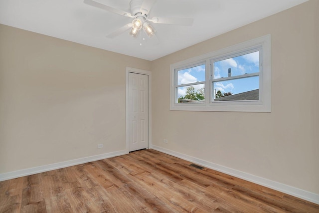18024 Birch Ave, Country Club Hills, IL 60478 - unfurnished room with baseboards, light wood-style floors, and a ceiling fan