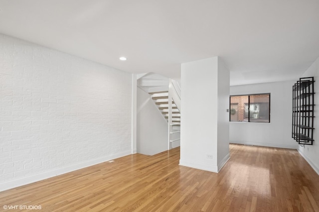 3759 N Kenmore Ave Unit A, Chicago, IL 60613 - unfurnished room with brick wall, stairway, wood finished floors, baseboards, and recessed lighting