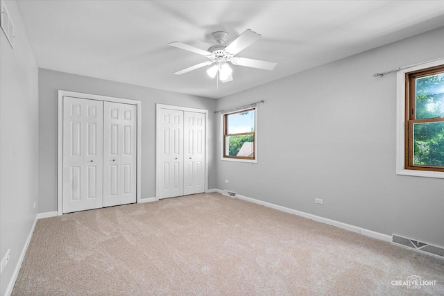 6382 Twin Oaks Ln, Lisle, IL 60532 - unfurnished bedroom featuring multiple closets, carpet floors, and a ceiling fan