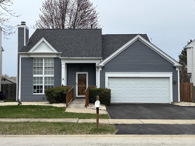 3238 Gresham Ln E, Aurora, IL 60504 - view of front of property featuring asphalt driveway, a garage, a shingled roof, and a chimney