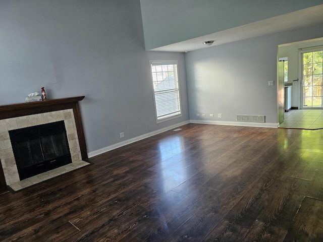 3238 Gresham Ln E, Aurora, IL 60504 - unfurnished living room featuring wood finished floors, baseboards, and a fireplace