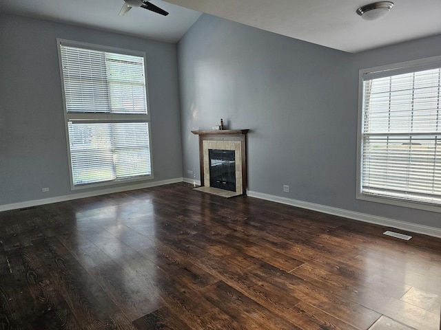 3238 Gresham Ln E, Aurora, IL 60504 - unfurnished living room featuring a tiled fireplace, dark wood finished floors, baseboards, and a ceiling fan