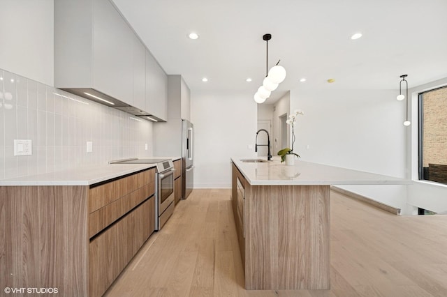 220 S Oakley Blvd, Chicago, IL 60612 - kitchen featuring modern cabinets, appliances with stainless steel finishes, a sink, an island with sink, and recessed lighting