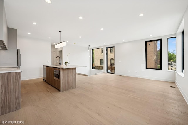 220 S Oakley Blvd, Chicago, IL 60612 - kitchen with modern cabinets, a sink, stainless steel appliances, light countertops, and light wood-type flooring
