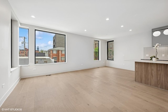 220 S Oakley Blvd, Chicago, IL 60612 - unfurnished living room featuring light wood finished floors, recessed lighting, and baseboards