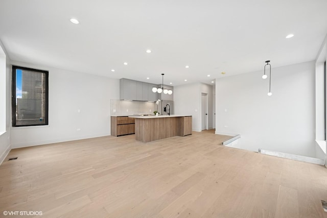 220 S Oakley Blvd, Chicago, IL 60612 - kitchen with open floor plan, an island with sink, light countertops, modern cabinets, and light wood-type flooring