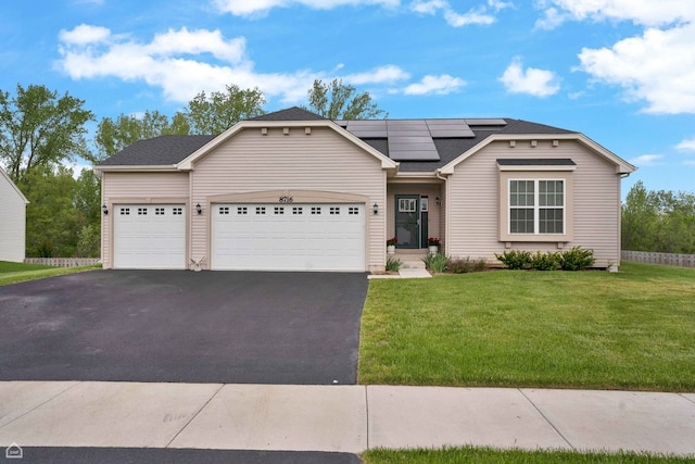 8716 Pebble Creek Ct, Wonder Lake, IL 60097 - view of front of house with driveway, solar panels, an attached garage, a front lawn, and a shingled roof