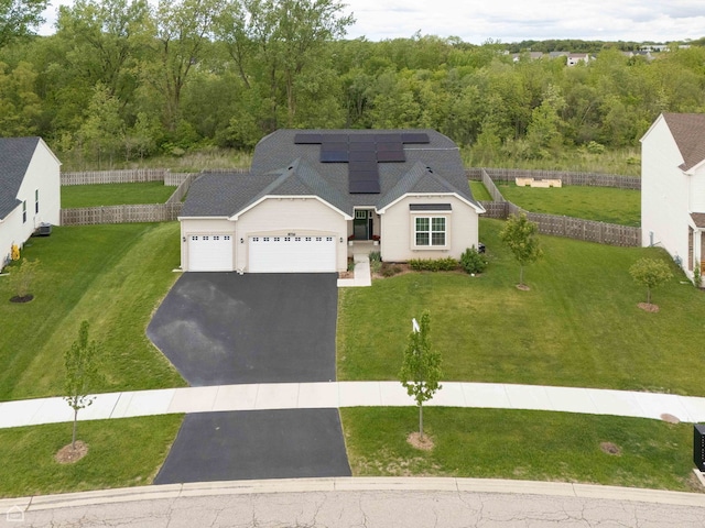 8716 Pebble Creek Ct, Wonder Lake, IL 60097 - view of front of house with asphalt driveway, an attached garage, and roof mounted solar panels