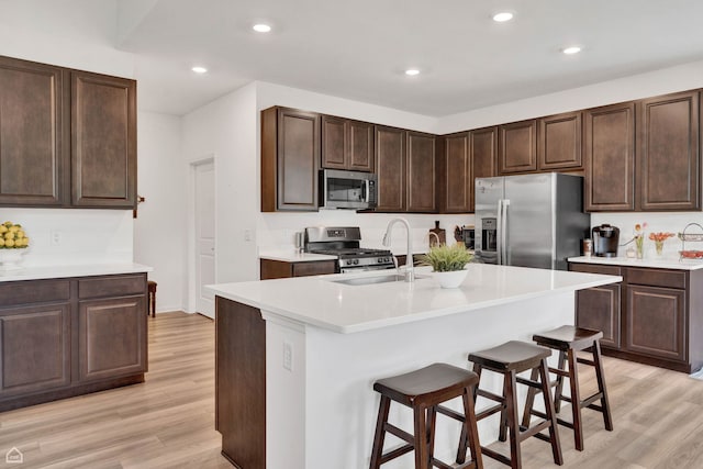 8716 Pebble Creek Ct, Wonder Lake, IL 60097 - kitchen featuring stainless steel appliances, a sink, light wood finished floors, light countertops, and recessed lighting