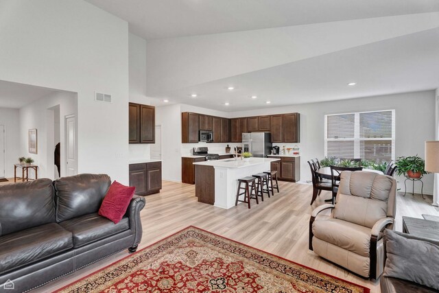 8716 Pebble Creek Ct, Wonder Lake, IL 60097 - living area featuring light wood-style flooring, recessed lighting, and a high ceiling