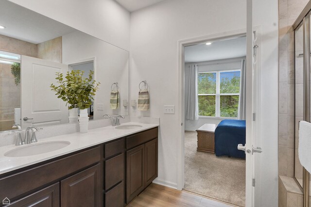 8716 Pebble Creek Ct, Wonder Lake, IL 60097 - full bathroom with ensuite bathroom, double vanity, tiled shower, wood finished floors, and recessed lighting