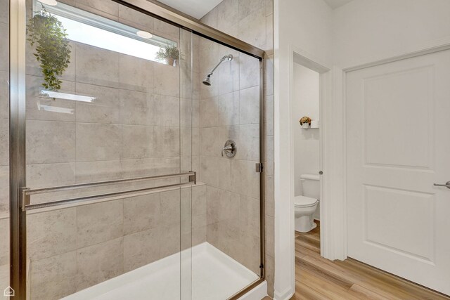 8716 Pebble Creek Ct, Wonder Lake, IL 60097 - full bath featuring toilet, a stall shower, and wood finished floors
