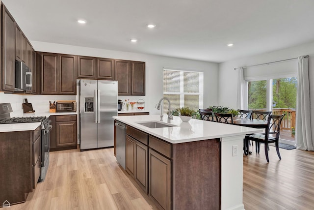 8716 Pebble Creek Ct, Wonder Lake, IL 60097 - kitchen featuring appliances with stainless steel finishes, a sink, light wood finished floors, light countertops, and recessed lighting