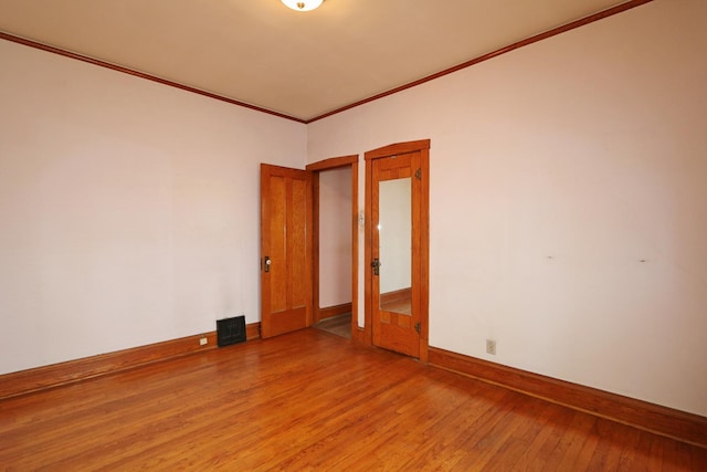 4327 W Henderson St, Chicago, IL 60641 - spare room featuring light wood-style flooring, baseboards, and ornamental molding