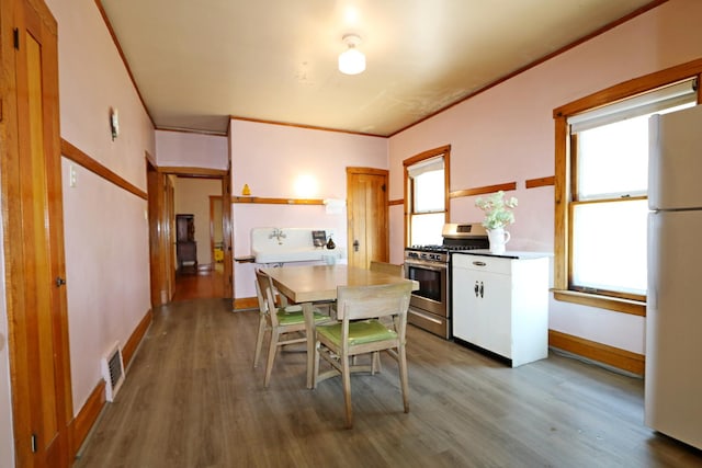 4327 W Henderson St, Chicago, IL 60641 - kitchen with stainless steel range with gas stovetop, freestanding refrigerator, wood finished floors, healthy amount of natural light, and crown molding