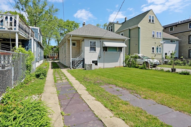 4327 W Henderson St, Chicago, IL 60641 - back of house with a chimney, entry steps, and a shingled roof