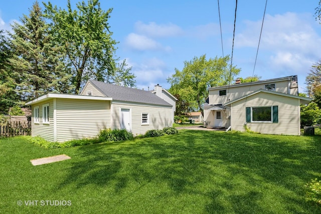 back of property featuring a yard and central AC unit