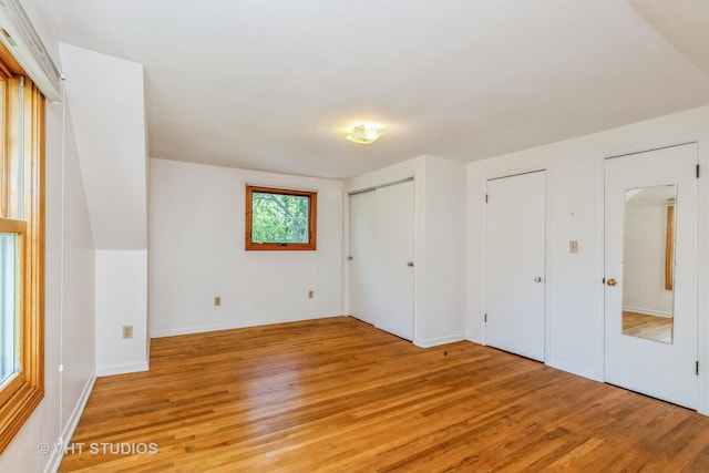 unfurnished bedroom featuring light wood-style floors and baseboards